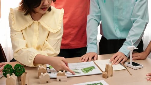 Business team consulting and analyzing green power graph usage. Delineation.
