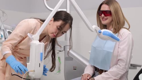 Dentist with Patient Using Dental Tool in Office