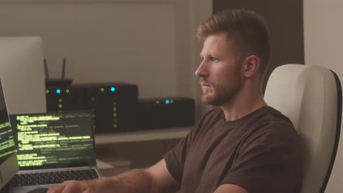 Portrait of Programmer Working in Server Room