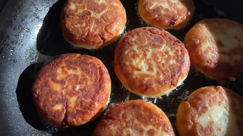 Pancakes Frying in Hot Oil in Frying Pan