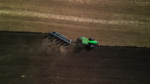Tractors plowing the field in Ukraine