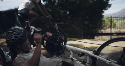 Athletes Ride Bicycles on Road in Urban Nature