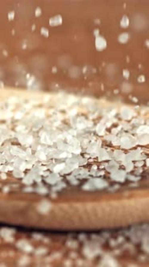 Sea Salt Crystals Fall Onto a Wooden Spoon Filmed on a Highspeed Camera at 1000 Fps