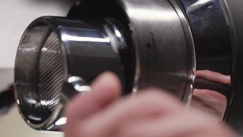 Inserting portafilter in coffee machine to prepare coffee