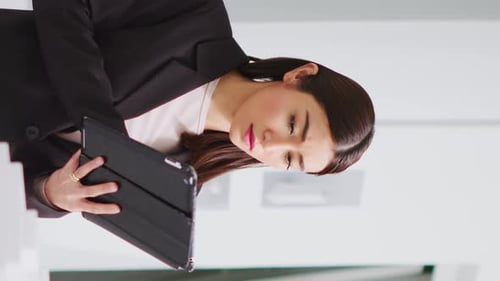 Woman Uses Tablet in Modern Office Space