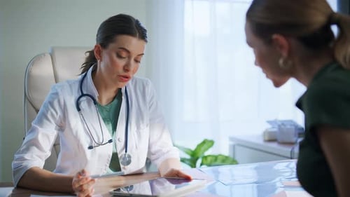 Hospital Physician Explaining Tablet to Woman Patient at Medicare Visit Closeup