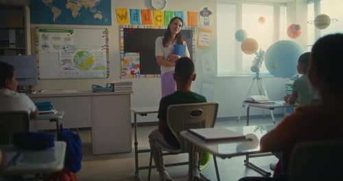 Female Teacher Starting Lesson Teaching Geography to Primary School Children in Multiethnic