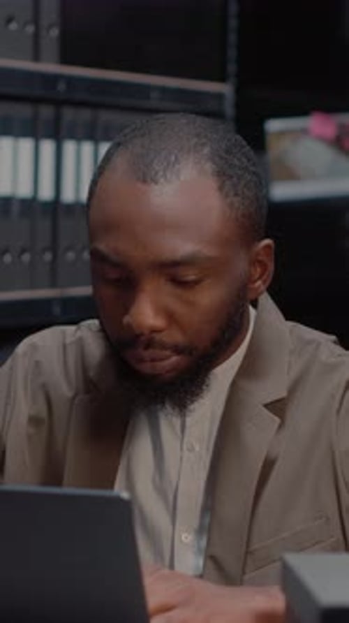 Bearded Man Using Laptop and Drinking Coffee