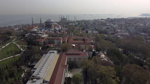 Drone shot of Hagia Sophia and the Blue Mosque in Istanbul - drone is approaching from Bosporus side