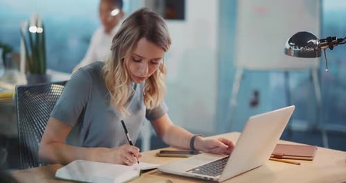 Woman Working at Laptop in Modern Office