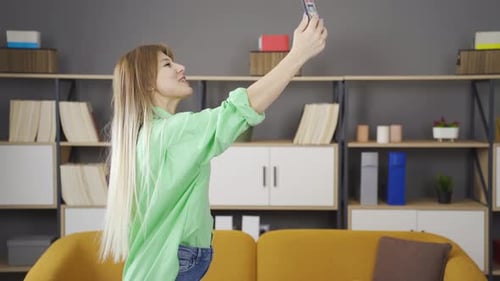 Young Woman Holding Phone Video Calling Indoors