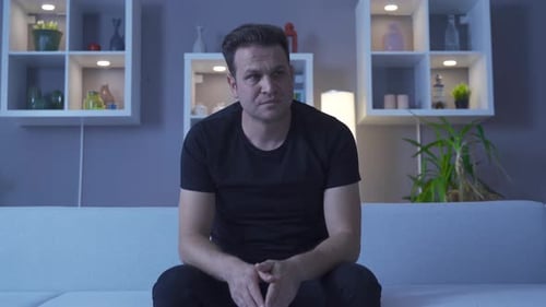 Distressed Man Sits Alone and Cries