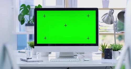 Computer with Green Screen on a Modern Desk
