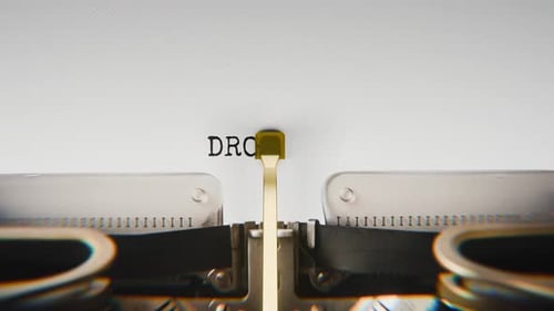 Old mechanical typewriter typing Drought in a close-up view.