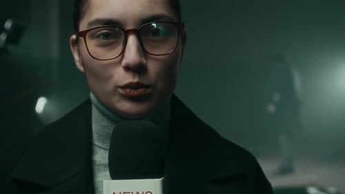 Female Reporter Giving a Live Broadcast at Night