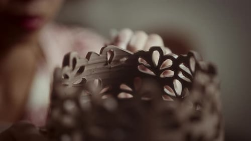 Artisan Carving Flower Cutouts into Ceramic Pot