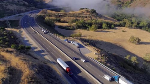 Broken down truck on a foggy morning along a highway near San Luis
Obispo, California - aerial orbit