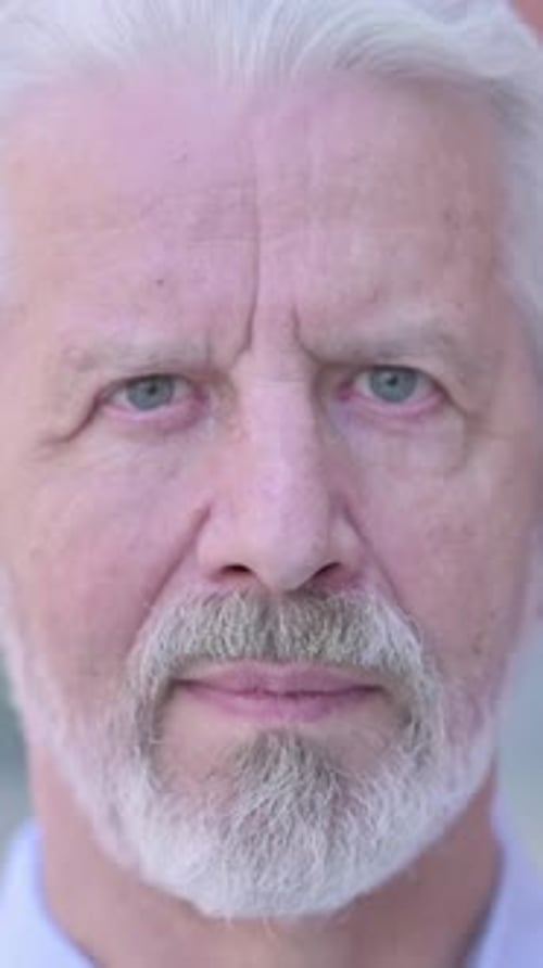 Close Up of Old Man Face Looking at Camera, vertical video