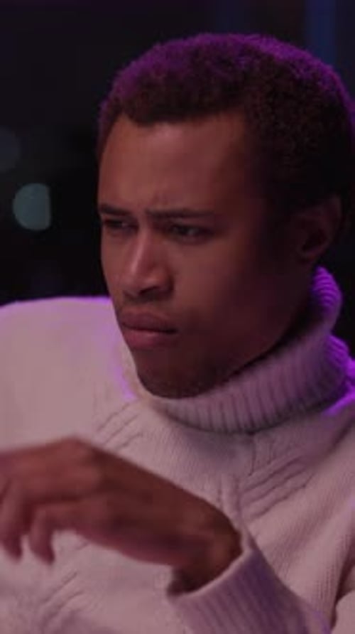 A Comedic Video Shows a Man in a Turtleneck Making Funny Faces