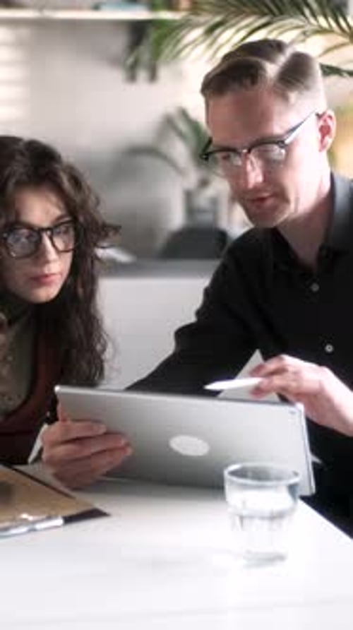 In Creative Office Productive Coworkers Standing at the Table Company Meeting Businessman And Woman