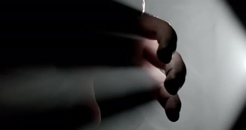 Reaching Hand in Smoky, Dark Environment