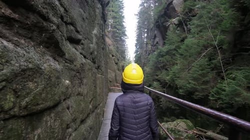 Person Walks Through Rocky Canyon Path
