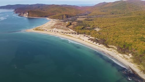 an Aerial View of a Large Body of Water Surrounded By Mountains and Trees