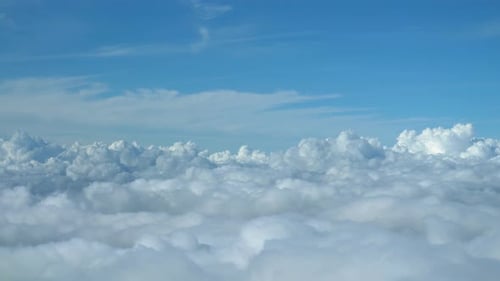 Airplane flying over the clouds view from cockpit