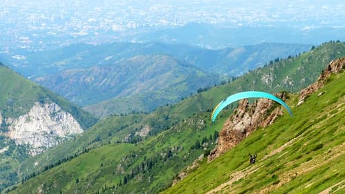 Paraglider Flying Over Mountains