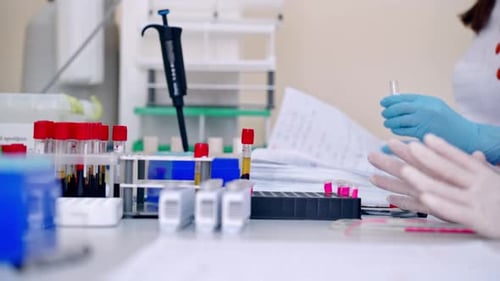 Medical Professionals Conduct Lab Tests with Pipette