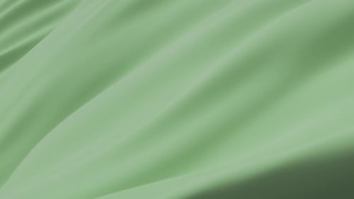 Tissu fluide vert menthe doux créant une surface lisse et élégante avec des mouvements subtils, des plis et une texture minimale