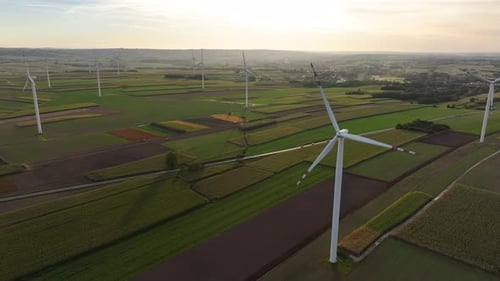 Wind Turbines Spinning on Green Fields, Aerial View