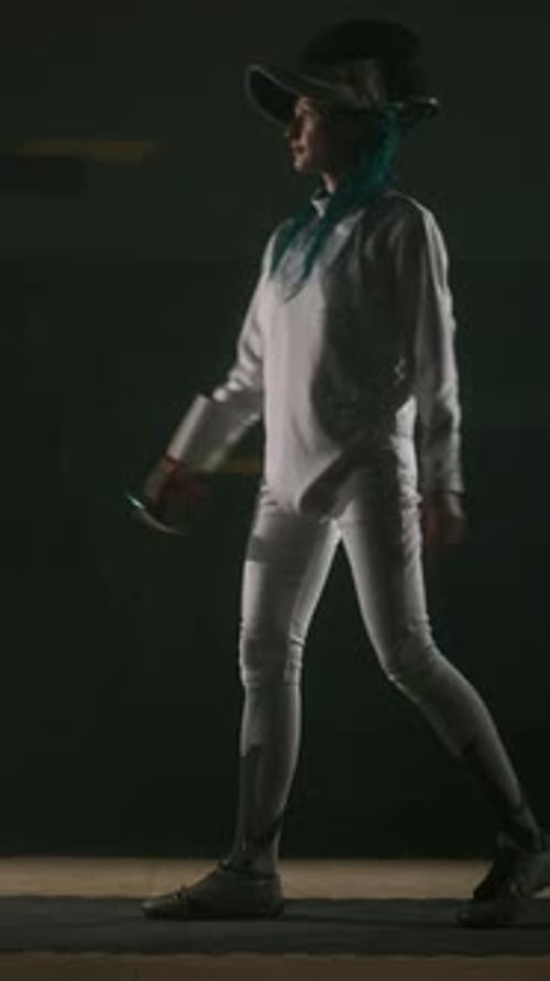 Vertical of Fencer Putting on Epee Mask and Taking Starting Pose with Foil Sword