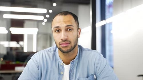 Webcam view. Young adult african american employee watching video call online conference looking