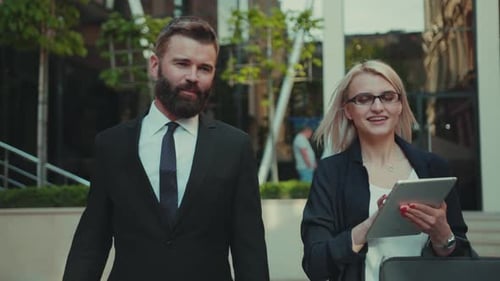 Successful Business Man and Woman Talking Walking and Use Tablet Computer Together at Outdoor