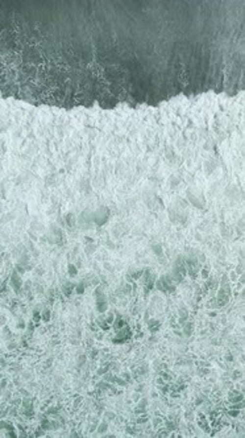 Vertical Video of Rough Surface Waves Breaking Under Cloudy Weather in Sea