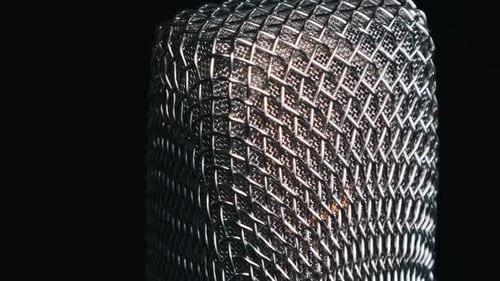 Studio Microphone Rotates on a Black Background CloseUp