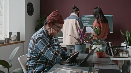 Indian Male Programmer Working on Code during Routine Workday in Office