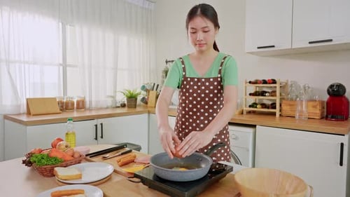 Young Woman Cooking Breakfast at Home in Kitchen