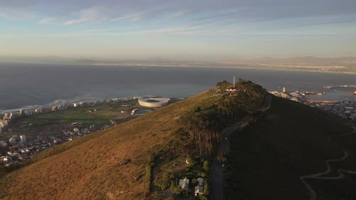 Descending Crane Cinematic Shot of Cape Town's Signal Hill With Green Point Park and Stadium During