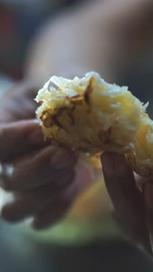 Close Up of a Person Holding Pastry