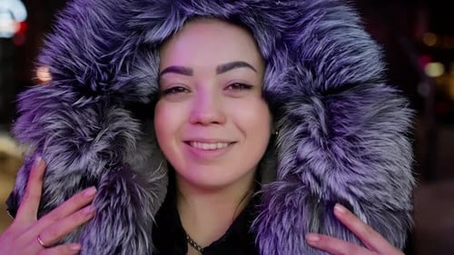 Woman Smiling Under Hood of Fur Coat