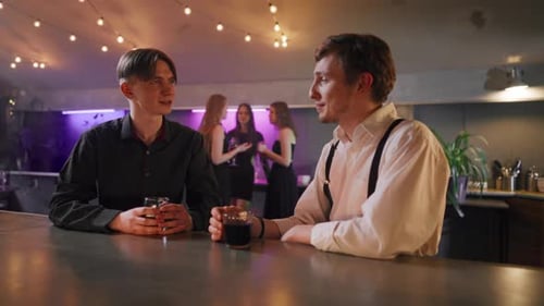 Two Men Friends Talking in Night Bar Young Joyful Men Resting in Club Talking Chatting Drinking