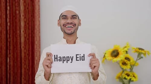 Muslim Man Holding Happy Eid Poster