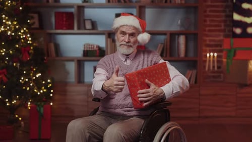 Senior Man in Wheelchair Holding Christmas Gift