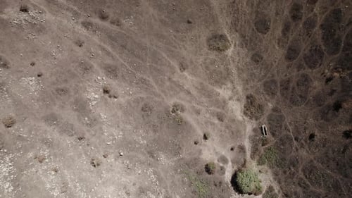 Aerial top-down shot of the burnt land after the huge wildfires in 2021 in Sardinia - the black soil