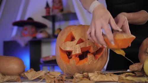 Carving Pumpkins with Woman Hands Preparing Halloween Jackolantern