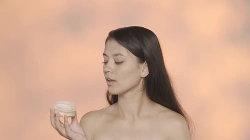 Closeup Studio Shot of Beautiful Female Model Brunette Girl Holding Rose Flower and Looking at the