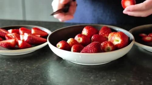 Preparing Sweet Strawberries by Slicing Ripe Fruit