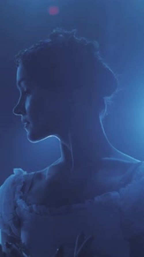 beautiful ballerina in ballet dress standing in theater hall and preparing to start the performance.